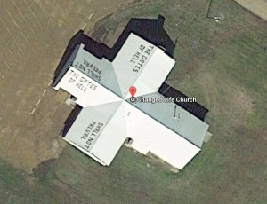 Aerial View of Changed Life Church building with text "The Gates of Hell Shall Not Prevail" on rooftop